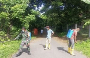 Babinsa Koramil 01/Sukajaya dan Petugas Kebersihan Kompak Bersihkan Bahu Jalan di Gampong Paya